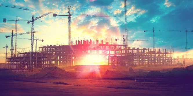 Sunset landscape.Construction cranes and buildings