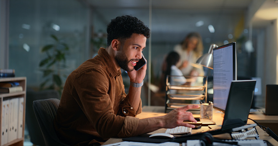 Night, business and man with laptop, phone call or communication in office. Person, employee or consultant in workplace, computer or connection with digital app, conversation or contact with internet