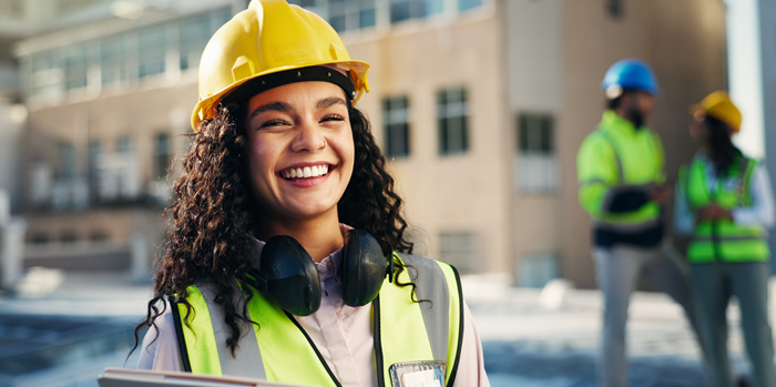 female construction worker smiling - workplace health and safety